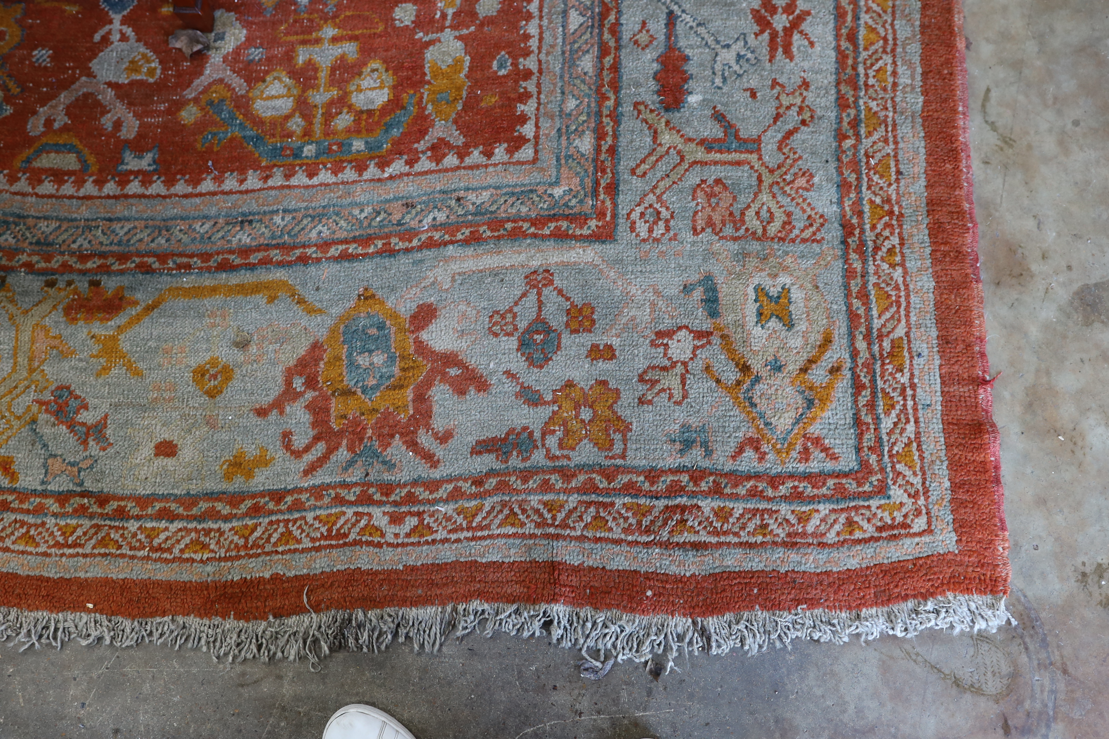 An Afghan red ground carpet, 395 x 310cm